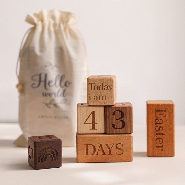 Montessori Milestone Blocks, a set of handcrafted wooden blocks featuring text and numbers, ideal for tracking milestones and enhancing fine motor skills.