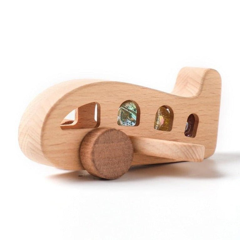 Montessori Wooden Plane made of beech wood, featuring windows and a rattling sound, designed for sensory engagement and curiosity in young children.