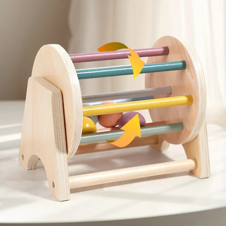 Montessori Wooden Rolling Ball Drum showcasing colorful sticks and balls, designed for early learning and enhancing hand-eye coordination, from Oliver & Company Montessori Toys.