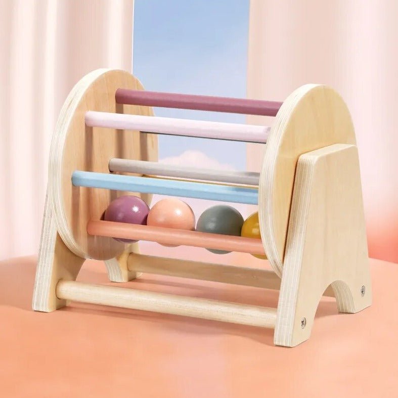 Montessori Wooden Rolling Ball Drum, a wooden toy with colorful balls, designed to enhance hand-eye coordination and color recognition in early childhood education.
