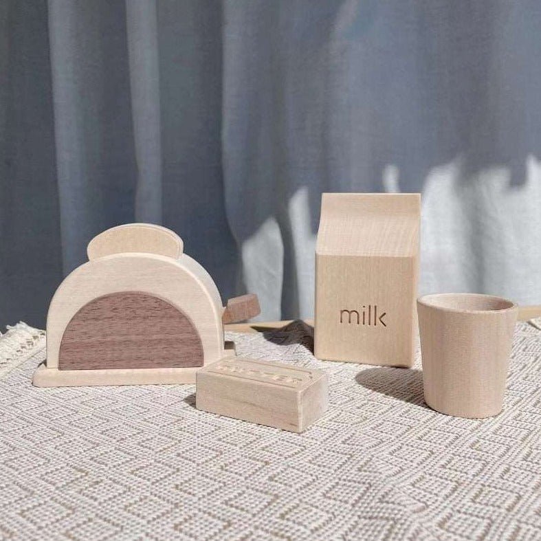 Montessori Wooden Toaster Set featuring a carved wooden toaster and accessories on a table, perfect for imaginative play and skill-building in children.