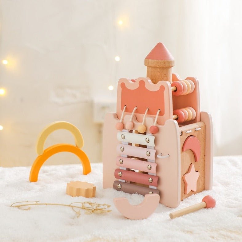 Montessori Wooden Toy Castle on a table features a yellow and orange wooden arch, designed to stimulate toddler development with interactive elements.