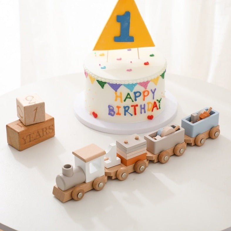 Montessori Wooden Train Set birthday cake design with colorful flags, featuring a miniature train, perfect for imaginative and educational play.