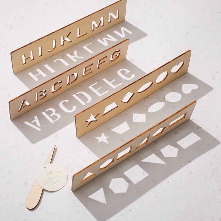 Montessori Writing & Tracing Boards showcasing alphabet stencils and a white tag, designed to enhance preschoolers' writing skills through interactive learning.