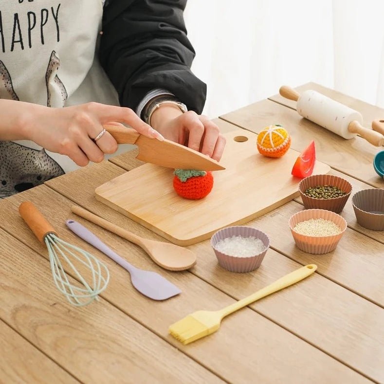 Child using Wooden and Silicone Kitchenware Sets, featuring a cutting board and utensils, for imaginative play and skill development. Part of eco-friendly Montessori toys collection.