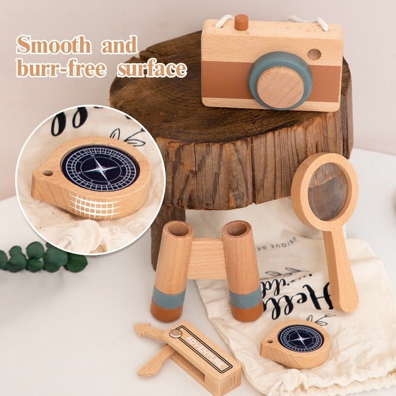 Wooden Montessori Outdoor Adventure Set featuring a compass, magnifying glass, and other wooden toys on a table, ideal for nature exploration and learning.