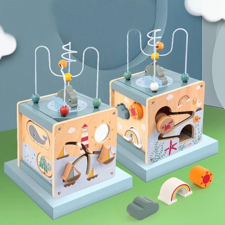 Wooden Ocean Activity Cube featuring interactive elements like a bead maze, shape sorter, and sea-themed puzzles, designed for toddlers' educational play.