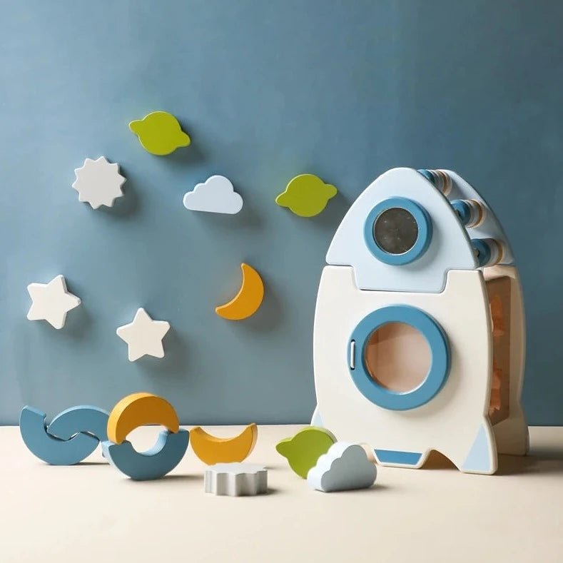 Wooden Rocket 5-in-1 Montessori Toy Set featuring a wooden rocket with stars and clouds, enhancing imaginative play and skill development for young explorers.